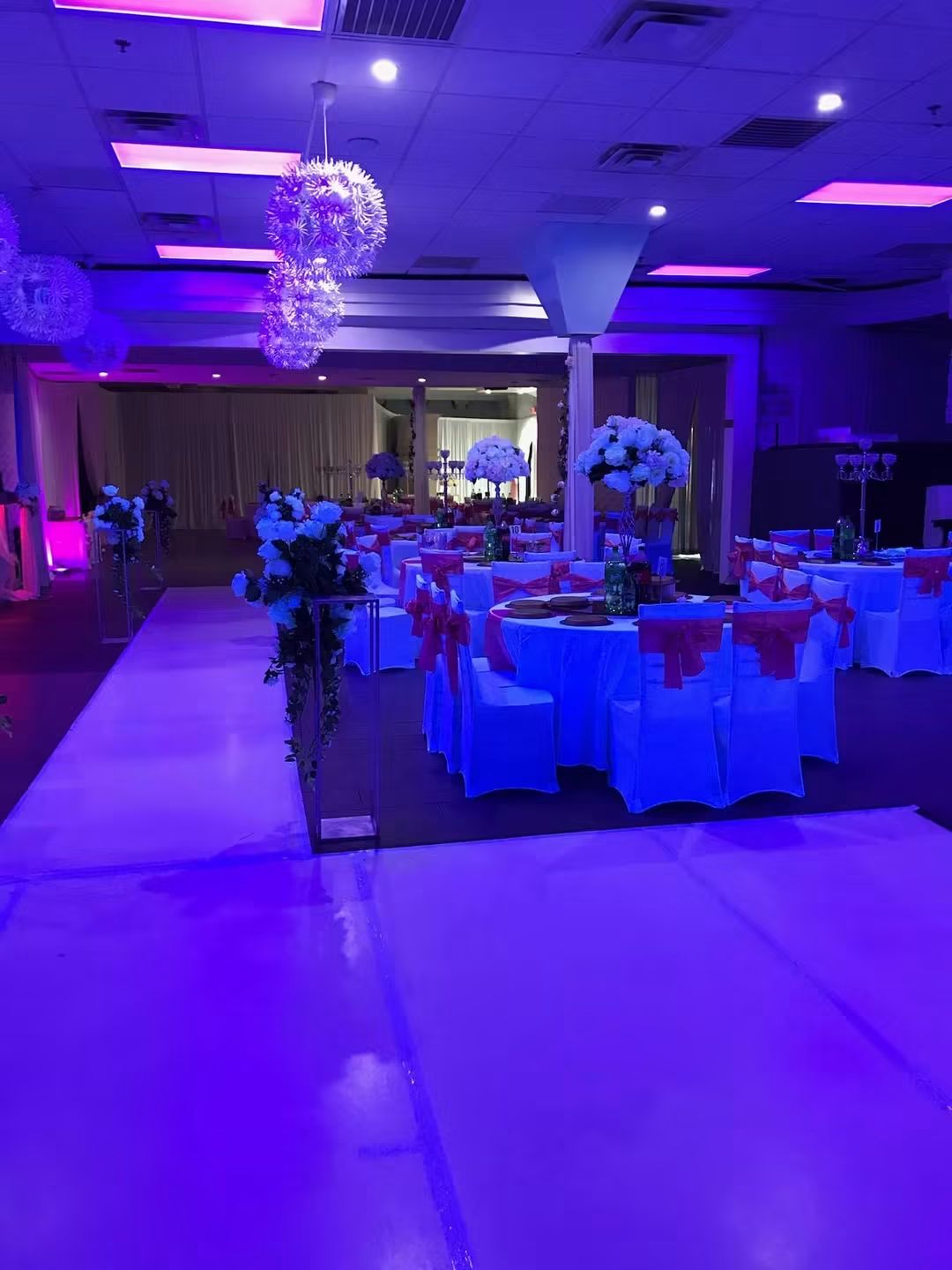 NDC Club banquet tables and dance floor illuminated in purple